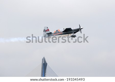 PUTRAJAYA, MALAYSIA - MAY 17, 2014: World champion Hannes Arch from Austria, in an Edge 540 V3 plane flies in the skies of Putrajaya, Malaysia at the Red Bull Air Race World Championship.