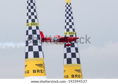 PUTRAJAYA, MALAYSIA - MAY 17, 2014: Pete McLeod from Canada in his Edge 540 V3 plane flies through the race course during the qualifying session of the Red Bull Air Race World Championship 2014.