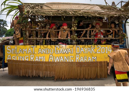 SARAWAK, MALAYSIA: JUNE 1, 2014: People of the Bidayuh tribe, an indigenous native people of Borneo, take part in a street parade on board a lorry to celebrate the Gawai Dayak festival.