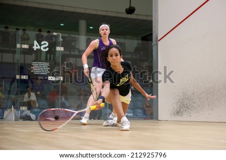 AUGUST 19, 2014 - KUALA LUMPUR, MALAYSIA: Nouran Gohar (Egypt) hits a return at the front court while playing Sarah-Jane Perry (England) in the CIMB Malaysian Open Squash Championship 2014.