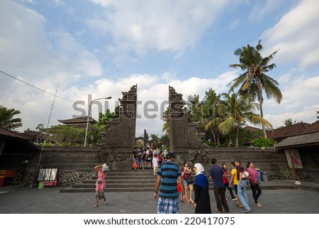 SEPTEMBER 17, 2014 - BALI, INDONESIA: Tourists and devotees enter the temple gates of the Tanah Lot Temple on Bali Island, Indonesia. Balinese practices Hinduism for their religion.