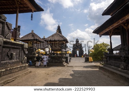 BALI, INDONESIA - SEPTEMBER 20, 2014: Tourists and devotees visit the Besakih Temple Complex, the largest and most important Hindu temple in Bali. Many significant religious events are held here.