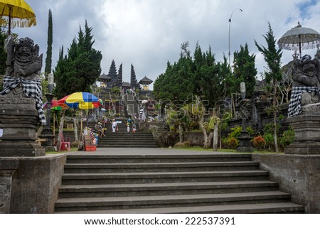 BALI, INDONESIA - SEPTEMBER 20, 2014: Tourists and devotees visit the Besakih Temple Complex, the largest and most important Hindu temple in Bali. Many significant religious events are held here.