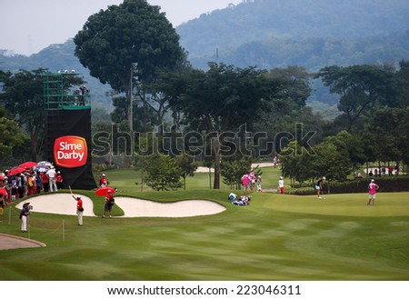 KUALA LUMPUR, MALAYSIA - OCTOBER 11, 2014: Golf fans and locals follow the leaders\' flight at the fourth hole of the KL Golf & Country Club during the 2014 Sime Darby LPGA Malaysia golf tournament.