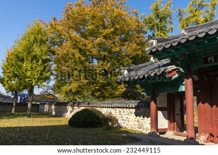 traditional walled Korean village homes with garden and parks, in autumn colors