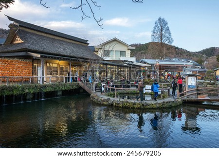 MOUNT FUJI - DECEMBER 03, 2015: Tourists visit Oshino village at the foot of Mount Fuji to view the snow-capped volcano. The water in the lakes of this village is fed by the melting snow from Mt Fuji.