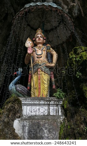 KUALA LUMPUR, MALAYSIA - JANUARY 31, 2015: A statue of Lord Muruga stands inside the Sri Mahamarriamman temple built inside a limestone cave. Hundreds of thousands of devotees come here for Thaipusam.