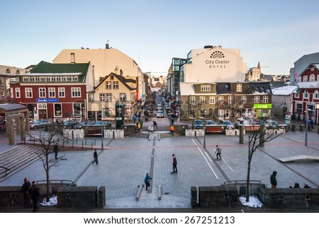 REYKJAVIK, ICELAND - MARCH 30, 2015: Young city dwellers ride on skateboards in the town center of Reykjavik on a winter evening, a lifestyle trend seen catching on in the young here.