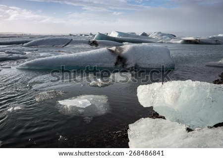 Glacier ice lagoon in Jokullsarlon, Iceland. The glacier breaks up into ice blocks in the lagoon before flowing out to sea as icebergs.