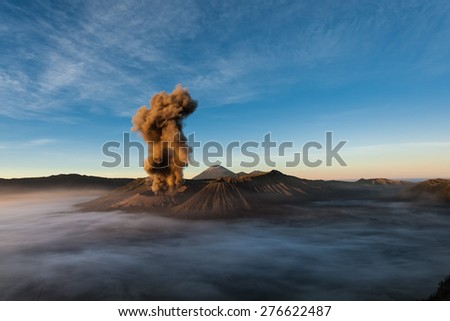 Mount Bromo erupts spewing out ash and smoke in the misty morning. Indonesia sits on the \'ring of fire\' with many active volcanoes and prone to earthquakes.