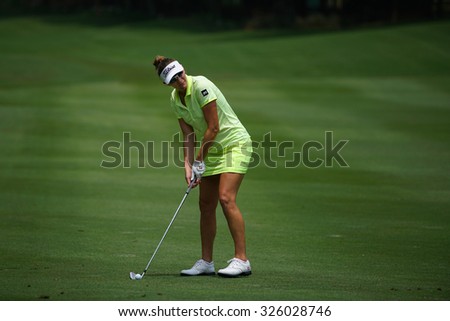 KUALA LUMPUR, MALAYSIA - OCTOBER 09, 2015: USA Brittany Lang plays from 6th hole fairway of the Kuala Lumpur Golf & Country Club at the 2015 Sime Darby LPGA Malaysia golf tournament.