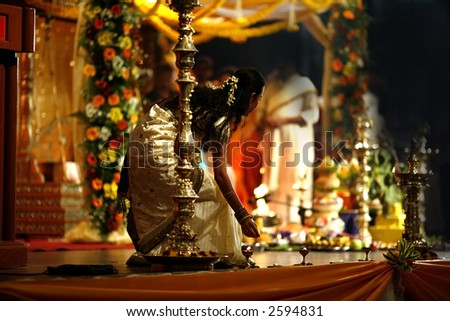 stock photo Girl offering prayers at Indian wedding
