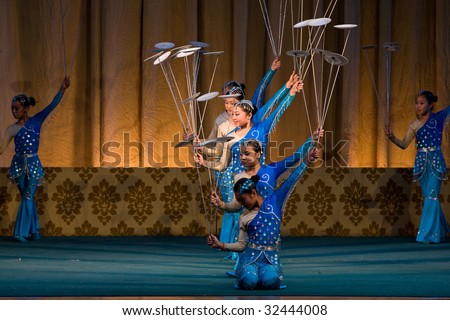 BEIJING, CHINA - JUNE 4: Balancing the spinning plates performed on stage. June 4, 2009 in Beijing, China.