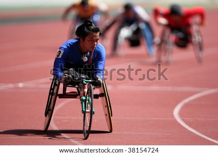 KUALA LUMPUR - AUGUST 16: Thailand\'s wheel chair athlete wins the 800m race at the track and field event of the fifth ASEAN Para Games on August 16, 2009 in Kuala Lumpur.