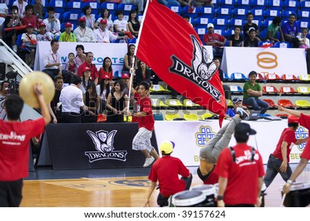 KUALA LUMPUR - OCTOBER 13: Fans cheering in the KL Dragons vs Brunei Barracudas match n the ASEAN Basketball League match. October 13, 2009 in Kuala Lumpur.