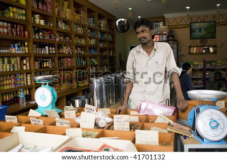 MALACCA - OCTOBER 31: An Indian shop assistant waiting for customers in a grocery and spices shop in the historic city of Malacca.  October 31, 2009 in Malaysia.