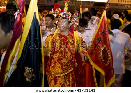 MALACCA - OCTOBER 31: A street parade with man dressed as emperor god and skewered in the cheeks, in a Taoism ceremony in Malacca.  October 31, 2009 in Malaysia