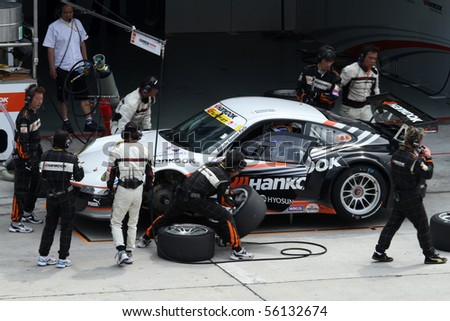 SEPANG, MALAYSIA - JUNE 21: The Hankook Porsche (33) in the pit lane for tire change at the Super GT International Series Round 4 race. June 21, 2010 in Sepang Malaysia.