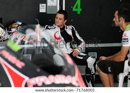 SEPANG, MALAYSIA - FEBRUARY 22: Randy de Puniet of Pramac Racing Team discusses with engineers at the 2011 MotoGP winter tests at the Sepang International Circuit on February 22, 2011 in Malaysia.