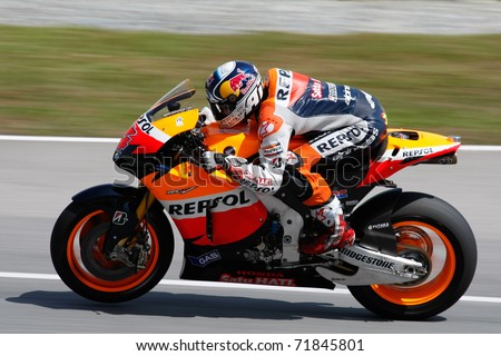 SEPANG, MALAYSIA - FEBRUARY 23: MotoGP rider Andrea Dovizioso of Repsol Honda Team practices at the 2011 MotoGP winter tests at the Sepang International Circuit. February 23, 2011 in Malaysia.
