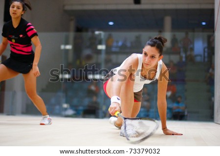 B.JALIL, MALAYSIA - MARCH 17: Camille Serme (France) in white takes on Delia Arnold (Malaysia) at the CIMB KL Open Squash Championship 2011 at the National Squash Centre on March 17, 2011 in B.Jalil, Malaysia.