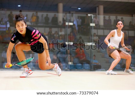 B.JALIL, MALAYSIA - MARCH 17: Camille Serme (France) in white takes on Delia Arnold (Malaysia) at the CIMB KL Open Squash Championship 2011 at the National Squash Centre on March 17, 2011 in B.Jalil, Malaysia.
