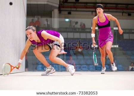 B.JALIL, MALAYSIA - MARCH 17: Kasey Brown (Australia) with headband plays Laura Massaro (England) at the CIMB KL Open Squash Championship at the National Squash Centre on March 17, 2011 in B.Jalil, Malaysia.