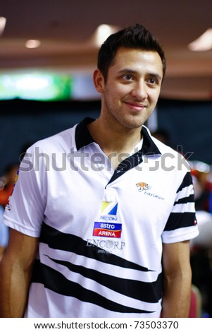 KUALA LUMPUR, MALAYSIA - MARCH 19: Mohd Azlan Iskandar, Malaysia enters the court in smiles for his semifinal game of the CIMB KL Open Championship 2011. March 19, 2011 Kuala Lumpur, Malaysia.
