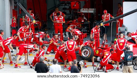 SEPANG, MALAYSIA - APRIL 8: Scuderia Ferrari F1 Team pit crew practice tire change in the pit-lane on the first practice day of the Petronas Malaysian F1 Grand Prix on April 8, 2011 Sepang, Malaysia.