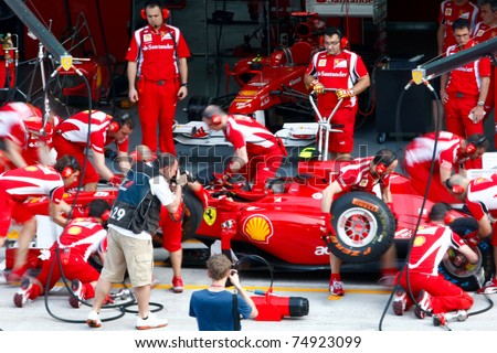 SEPANG, MALAYSIA - APRIL 8: Scuderia Ferrari F1 Team pit crew practice tire change in the pit-lane on the first practice day of the Petronas Malaysian F1 Grand Prix on April 8, 2011 Sepang, Malaysia.