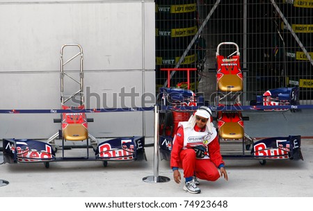 SEPANG, MALAYSIA - APRIL 8: Fireman on duty at the pit checks the lane condition on the first practice day of the Petronas Malaysian F1 Grand Prix on April 8, 2011 Sepang, Malaysia.