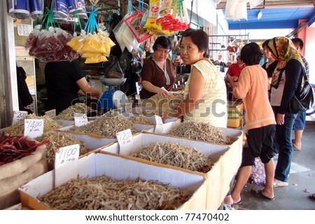 KUCHING - MAY 13: An unidentified lady waits for buyers at her grocery shop in town, May 13, 2011 in Kuching, Borneo Island. Most of the shops cater to the town-folks and a growing number of tourists.