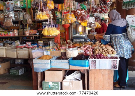 KUCHING - MAY 13: An unidentified lady buys food items at a grocery shop in town, May 13, 2011 in Kuching, Borneo Island. Most of the shops cater to the town-folks and a growing number of tourists.