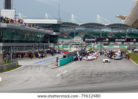 SEPANG - JUNE 19: GT cars take off on the starting grid for the warm-up lap of the Japan SUPER GT Round 3 race at the Sepang International Circuit on June 19, 2011 in Sepang, Malaysia.