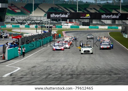 SEPANG - JUNE 19: GT cars take off on the starting grid for the warm-up lap of the Japan SUPER GT Round 3 race at the Sepang International Circuit on June 19, 2011 in Sepang, Malaysia.