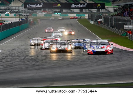 SEPANG - JUNE 19: Cars take off from a rolling start at the Japan SUPER GT Round 3 race at the Sepang International Circuit on June 19, 2011 in Sepang, Malaysia. The GT500 cars start in the front.