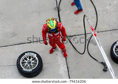 SEPANG - JUNE 19: LMP Motorsports\' driver waits for his car to come in for driver change, refueling and tire change during the Japan SUPER GT Round 3 race on June 19, 2011 in Sepang, Malaysia.