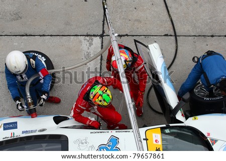 SEPANG - JUNE 19: LMP Motorsport team executes a drivers change during a pit-stop of the Japan SUPER GT Round 3 on June 19, 2011 in Sepang International Circuit, Malaysia.