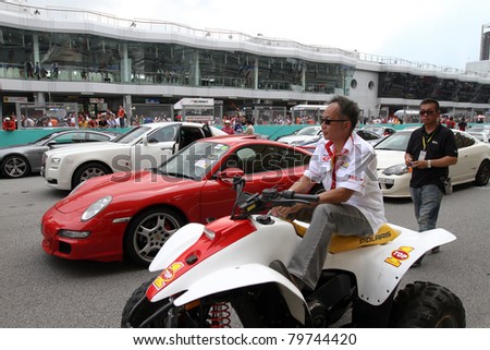 SEPANG, MALAYSIA - JUNE 19: Luxury cars and sports cars line up the race track on display during the Supercars Parade event in the Sepang International Circuit on June 19, 2011 in Sepang, Malaysia.