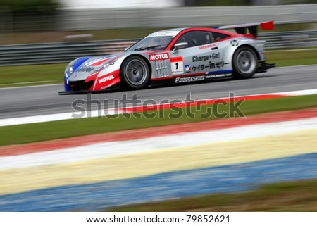 SEPANG, MALAYSIA - JUNE 18: The race car of Weider Honda Racing team puts in some practice laps in the Sepang International Circuit at the Japan SUPER GT Round 3 on June 18, 2011 in Sepang, Malaysia.