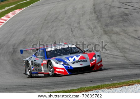 SEPANG, MALAYSIA - JUNE 18: The race car of Weider Honda Racing team puts in some practice laps in the Sepang International Circuit at the Japan SUPER GT Round 3 on June 18, 2011 in Sepang, Malaysia.