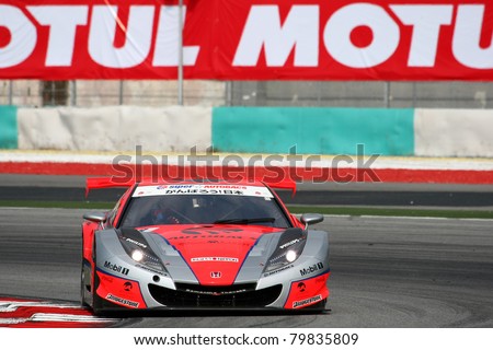 SEPANG - JUNE 18: The Honda HSV-010 car of Autobacs Racing Team Aguri puts in some practice laps in the Sepang International Circuit at the Japan SUPER GT Round 3 on June 18, 2011 in Sepang, Malaysia.