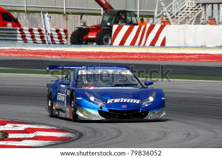 SEPANG - JUNE 18: The Honda HSV-010 car of Keihin Real Racing puts in some practice laps in the Sepang International Circuit during the Japan SUPER GT Round 3 on June 18, 2011 in Sepang, Malaysia.
