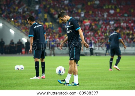 BUKIT JALIL, MALAYSIA - JULY 13: Arsenal\'s captain Robin van Persie warms up before the game against Malaysia on July 13, 2011, Bukit Jalil, Malaysia. English league team Arsenal is on an Asia Tour.