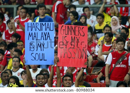 BUKIT JALIL, MALAYSIA - JULY 13: Soccer fans cheer during the Arsenal vs Malaysia game in the National Stadium on July 13, 2011, Bukit Jalil, Malaysia. English league team Arsenal is on an Asia Tour.