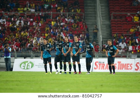 BUKIT JALIL - JULY 13: Arsenal players line up to form a wall against a Malaysian free-kick at goal on July 13, 2011 in Stadium Bukit Jalil, Malaysia. English league team Arsenal is on an Asia Tour.