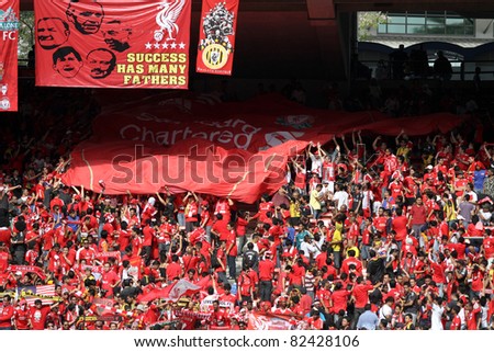 BUKIT JALIL, MALAYSIA - JULY 16: Liverpool soccer fans cheer during the game between Malaysia and English premier league club Liverpool in the National Stadium on July 16, 2011, Bukit Jalil, Malaysia.