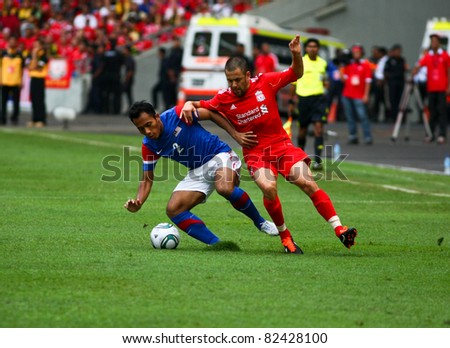 BUKIT JALIL - JULY 16: Mahalli Jasuli shields the ball from Liverpool\'s Joe Cole (red) in the game between Liverpool and Malaysia at the National Stadium on July 16, 2011, Bukit Jalil, Malaysia.