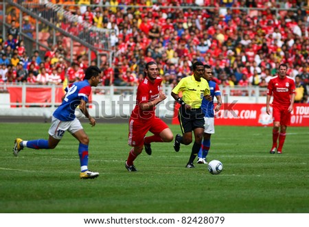BUKIT JALIL, MALAYSIA - JULY 16: Liverpool\'s Andy Carroll (red) dribbles the ball in the game against Malaysia at the National Stadium on July 16, 2011, Bukit Jalil, Malaysia. Liverpool won 6-3.