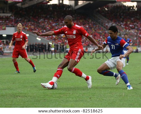 BUKIT JALIL - JULY 16: Liverpool\'s David Ngog (red) traps the ball with his foot in this game against Malaysia at the National Stadium on July 16, 2011, Bukit Jalil, Malaysia. Liverpool won 6-3.